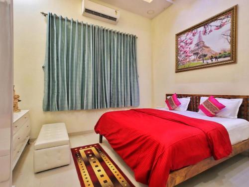 a bedroom with a red bed and a window at Shore Beats Villa in Mumbai