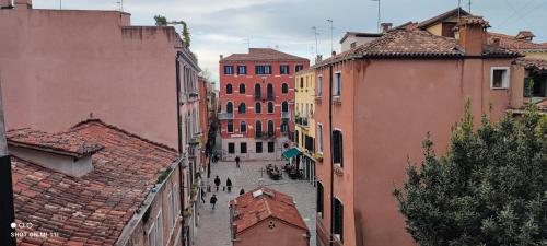 a group of people walking down a street between buildings at Corte Due Porte in Venice