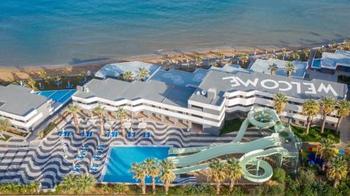 an aerial view of a resort with a water slide at Arina Beach Resort in Kokkini Khanion