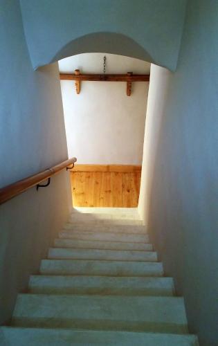 a staircase leading up to a room with wooden floors at Villa Limonicella in Barrydale