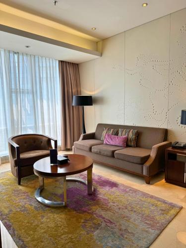 a living room with a couch and a coffee table at Ascott Kuningan Jakarta in Jakarta