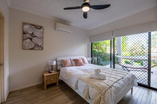 a bedroom with a bed and a ceiling fan at Deluxe 2-Bed Unit with Parking and Outdoor Area in Brisbane