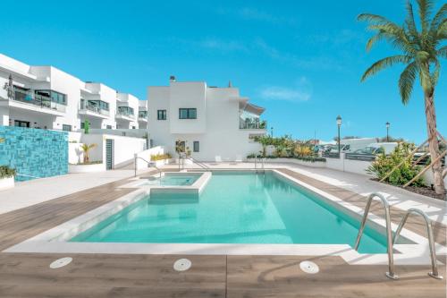 uma villa com piscina em frente a um edifício em New Luxurious house with rooftop terrace and pool em Nerja