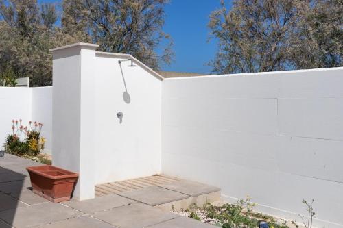 a white fence with a bench next to it at Rossella House in Mola di Bari