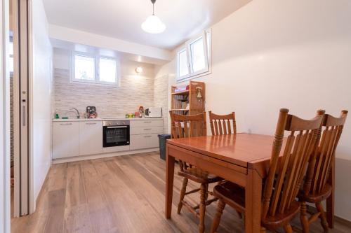 a kitchen and dining room with a wooden table and chairs at Rossella House in Mola di Bari