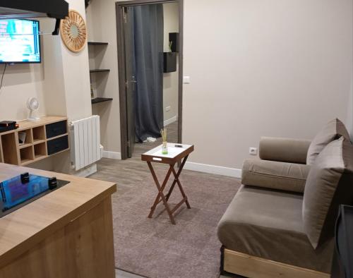 a living room with a couch and a table at Appartement 2 pièces a louer in Saint-Denis