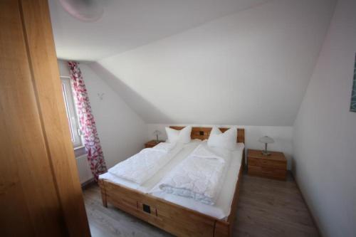 a bedroom with a large bed in a attic at K 99 - Ferienhaus mit Kamin & WLAN in Röbel an der Müritz in Röbel