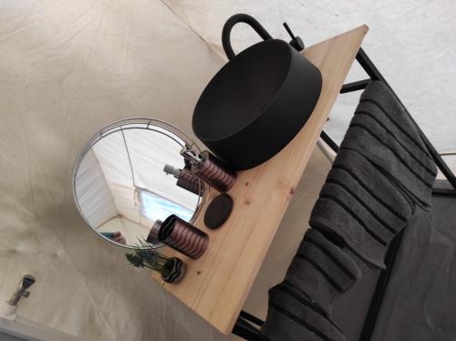 a mirror sitting on a table next to a bed at Glamping Casa Soarelui in Vama Veche