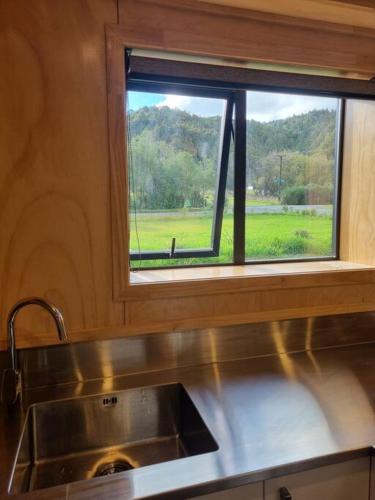 a kitchen with a sink and a window with a view at Blackball Connection in Blackball