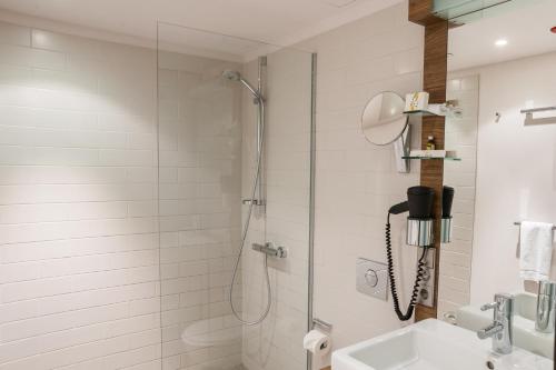 a bathroom with a shower and a sink at Hotel Stadtpalais in Cologne