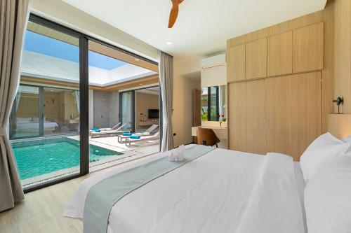 a bedroom with a bed and a swimming pool at Paradise Springs Samui Villas - Luxury 3BR in Koh Samui 