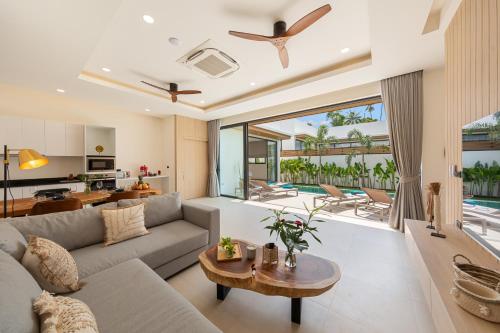a living room with a couch and a table at Paradise Springs Samui Villas - PSS10 - Luxury 3BR in Bophut