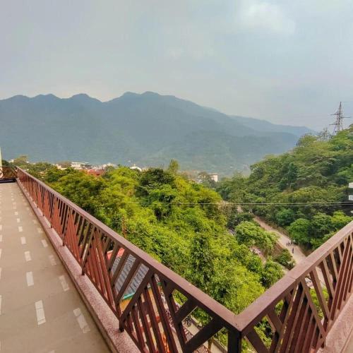 a wooden bridge with a view of a mountain at Hotel Dream Catcher in Rishīkesh