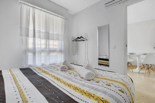 una camera bianca con un grande letto con asciugamani di Vistamarina B 210 By IVI Real Estate a Torremolinos