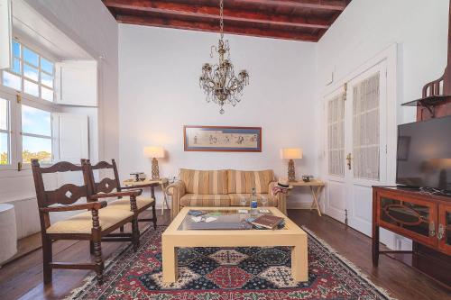 a living room with a couch and a table at Hotel Bodega EL GRIFO in San Bartolomé