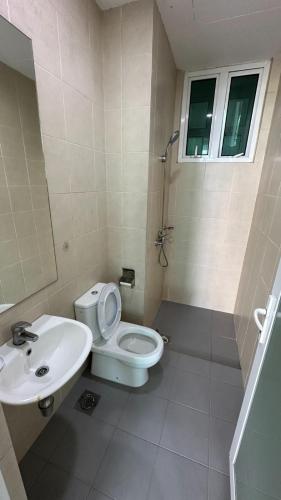 a bathroom with a toilet and a sink at Southbay Seaview Condo A10 #10minQueensbay #15minSPICE in Bayan Lepas