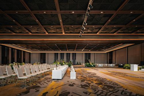a large banquet hall with white chairs and tables at Bali Beach Hotel in Sanur