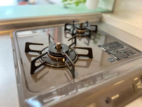 a stove top with two burners on top of it at OUCHI HOTEL Hatchobori in Hiroshima