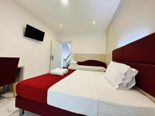 a bedroom with a red and white bed and a television at Dream Hub in Mestre