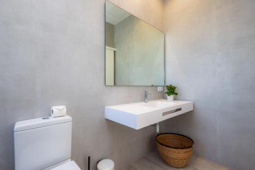 a bathroom with a white sink and a mirror at Son Crespi Vell 2 in Manacor