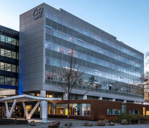 an office building with a sign on it at Cityden Zuidas in Amstelveen