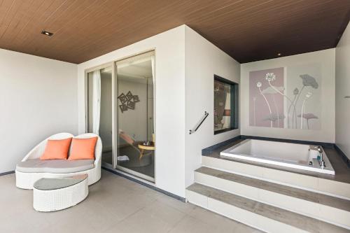 a bathroom with stairs leading to a tub at Cape Sienna Phuket Gourmet Hotel & Villas - SHA Extra Plus in Kamala Beach