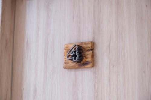 a wooden cutting board with a brush on a table at Onar Syros - Rustic Rooms in Ermoupoli
