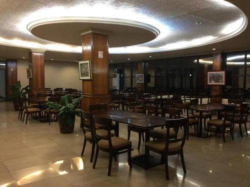 a dining room with tables and chairs in a restaurant at Dottie's Place Hotel & Restaurant in Butuan