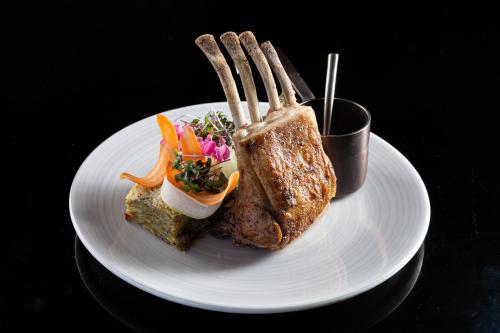 a plate with a piece of bread and a salad at Cape Sienna Phuket Gourmet Hotel & Villas - SHA Extra Plus in Kamala Beach