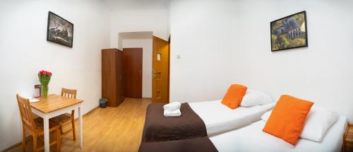 a bedroom with a bed and a table and a desk at Station Aparthotel in Kraków