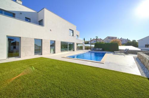 a house with a swimming pool and a yard at Villa Sia in Krk