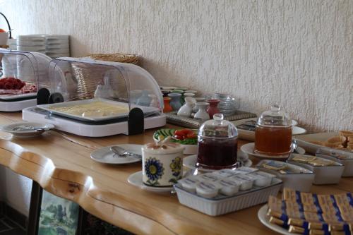 a table with food and a toaster on it at Hotel Carolaruh in Bad Elster