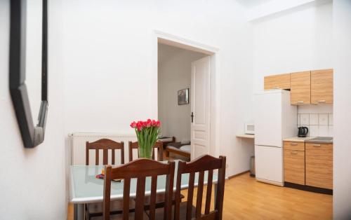 a kitchen and dining room with a table and chairs at Station Aparthotel in Kraków