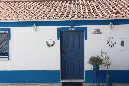 a blue and white house with a blue door at Rosa Mar in Cabeça de Carneiro