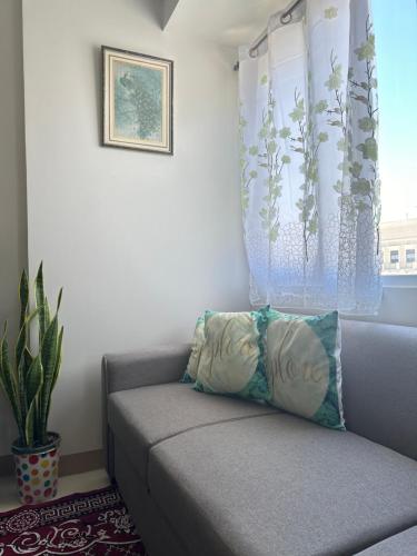 a couch sitting in a room with a window at Family room Casa Mia at SMDC Styles Residence Tower A in Iloilo City