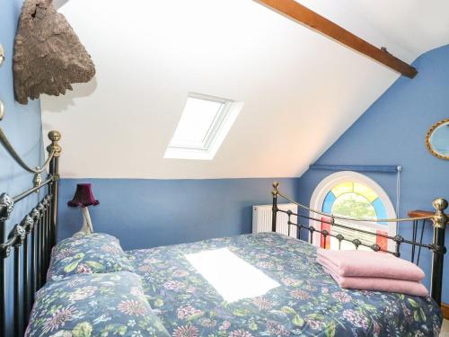 a bedroom with a bed and a window at The Old Chapel in Bawdeswell