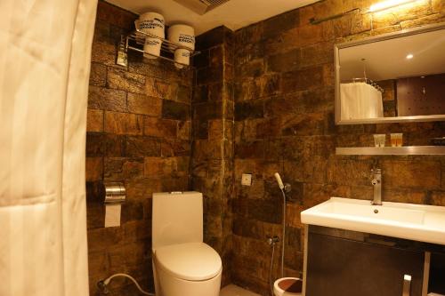 a bathroom with a toilet and a sink at Fu Wang Dominous Resort in Cox's Bazar