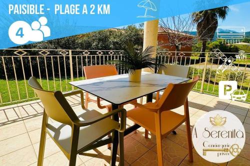 a table and chairs with a potted plant on a patio at T3 Serenità à 2km de la mer in Ventiseri