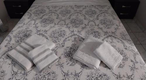 uma cama com duas toalhas e uma pilha de toalhas em SWEET APPARTMENT em Patra