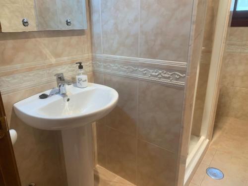 a bathroom with a sink and a shower at Apartamentos La Mina de Viñón. in Santa Eulalia