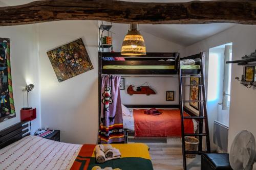 a bedroom with two bunk beds in a room at Le Moulin de Pascale in Espelette