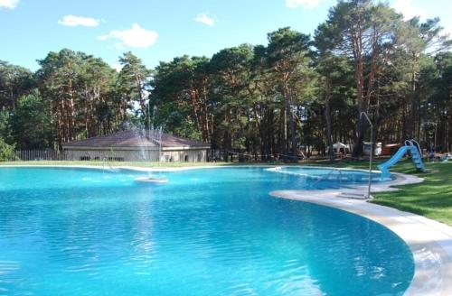 a large swimming pool with a water slide at Camping Urbion in Abejar