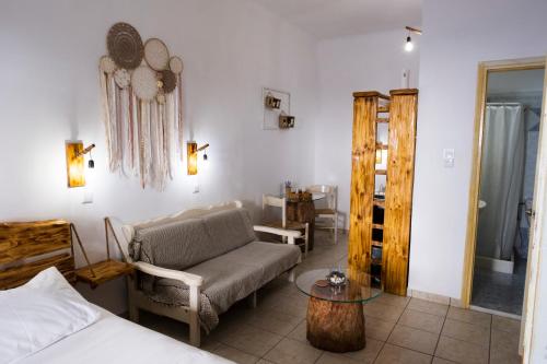 a living room with a couch and a table at Onar Syros - Rustic Rooms in Ermoupoli