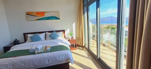 a bedroom with a bed and a large window at Sky Seaview Coron in Coron