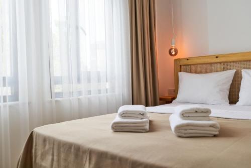 a bedroom with a bed with towels on it at Audo Local in Antalya