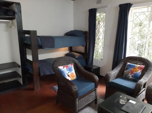 a living room with two chairs and a bunk bed at Sabie Star in Sabie