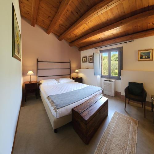 a bedroom with a large bed and a window at Relais Casa Mirabile in Menfi