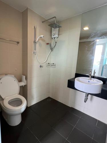 a bathroom with a toilet and a sink at The wide condo by Guide Sabai in Ban Tha Khreng