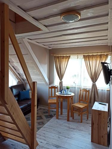 a living room with a couch and a table at Rodzinny zakątek "U Głuszków" Bieszczady in Myczkowce