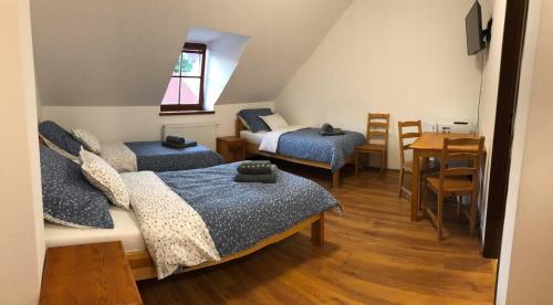 um quarto com duas camas e uma mesa e uma sala de jantar em Nicolsburg em Mikulov